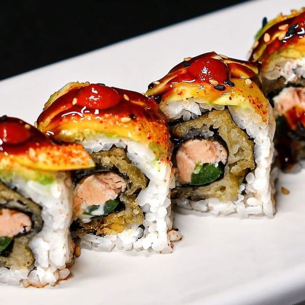 Himiko Sushi's salmon and tempura sushi rolls topped with avocado and sweet sauce.